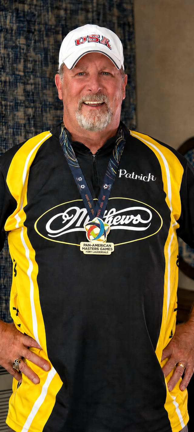 Coach Patrick wearing his Pan-American Masters Games gold medal