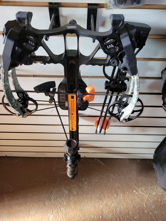 Mission crossbow with scope on the shop wall